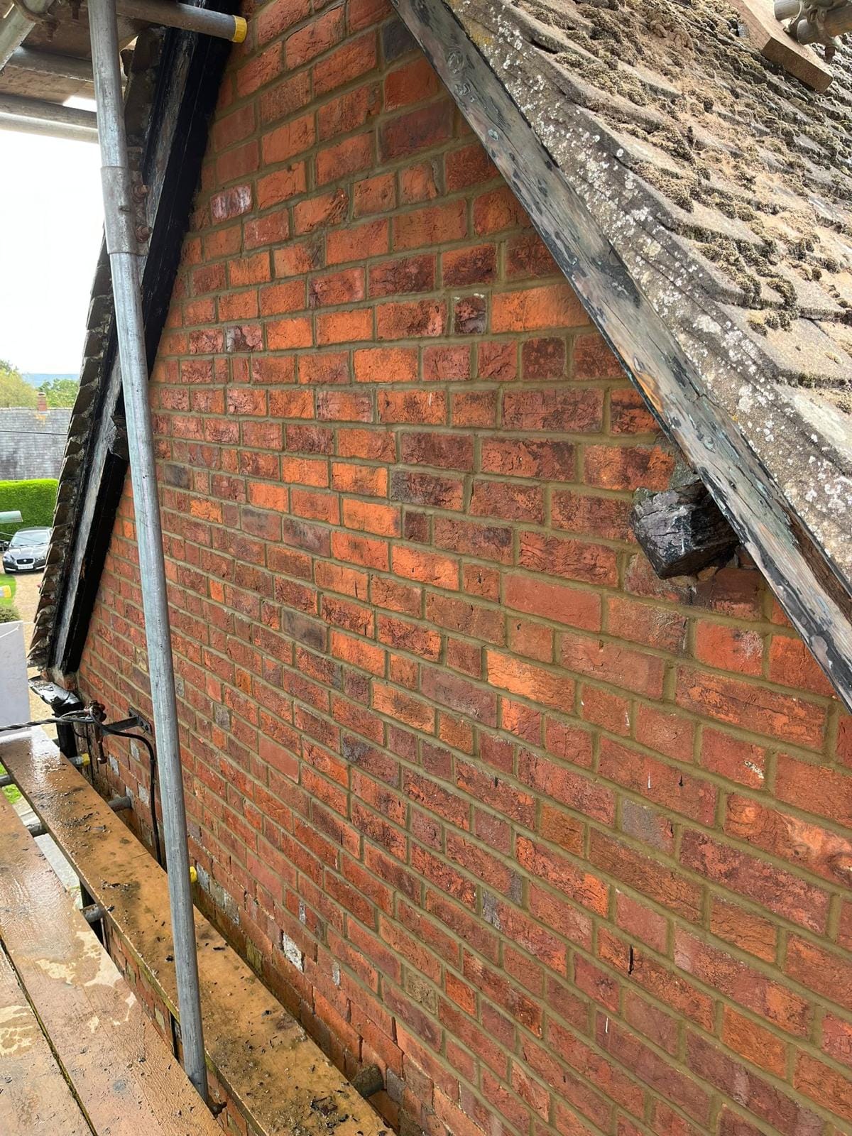 A rebuilt and extended brick boundary wall in Leighton Buzzard