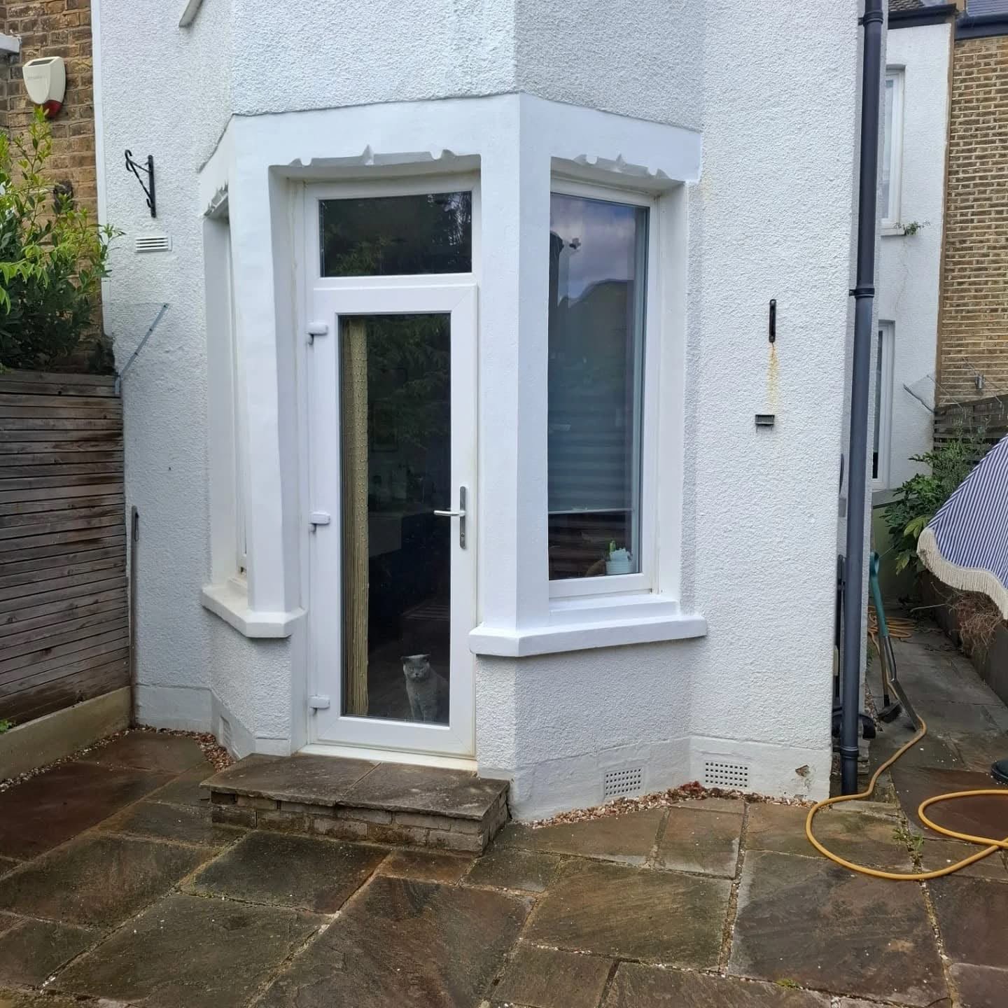A completed porch and rendered frontage by J P Building Services