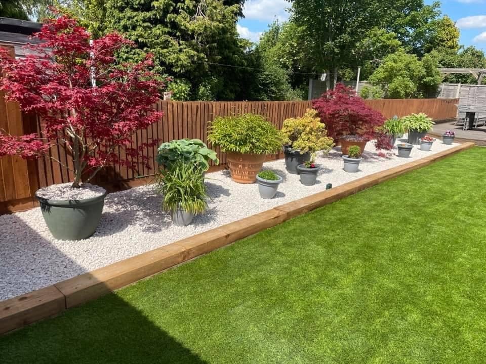 A landscaped garden with new paving and fencing