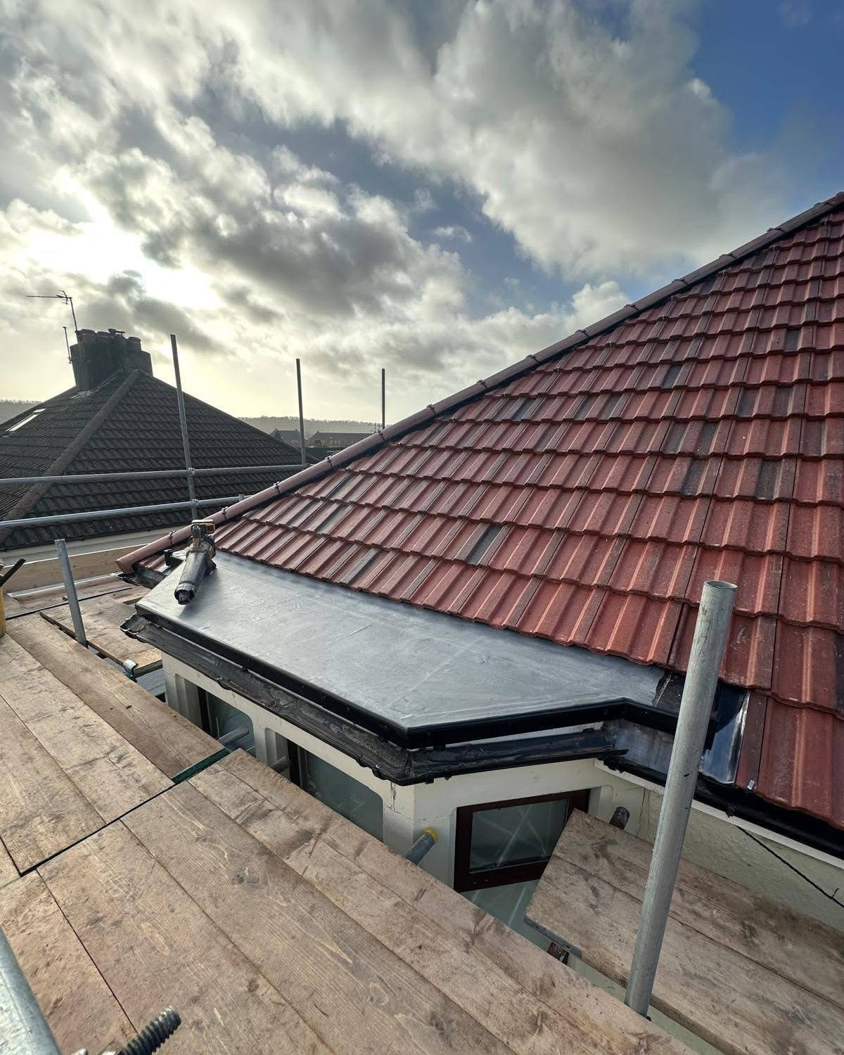 A newly tiled pitched roof on a house