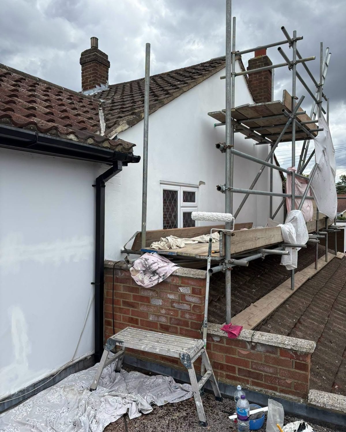A decorator painting an interior wall