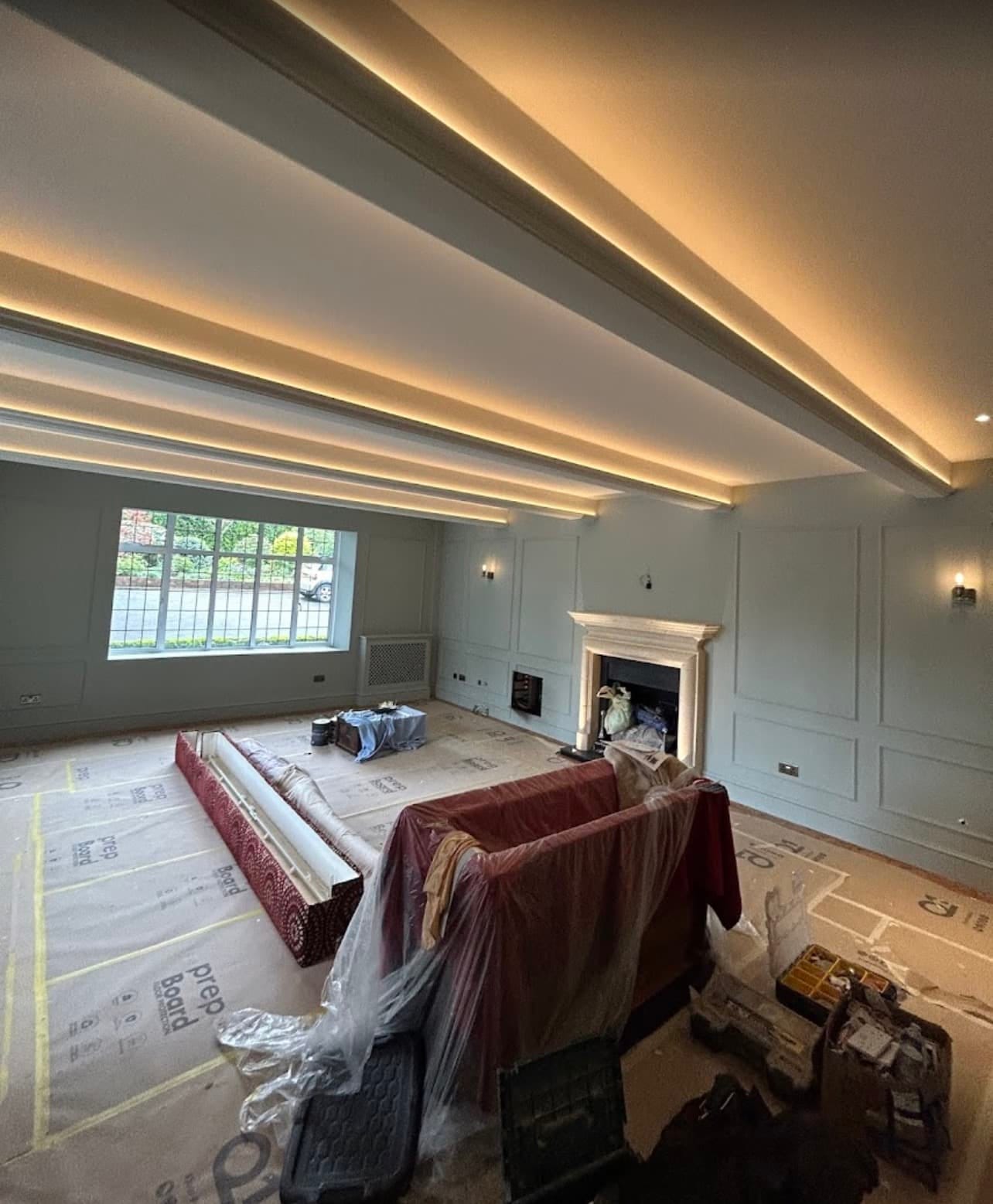 A decorator painting an interior wall